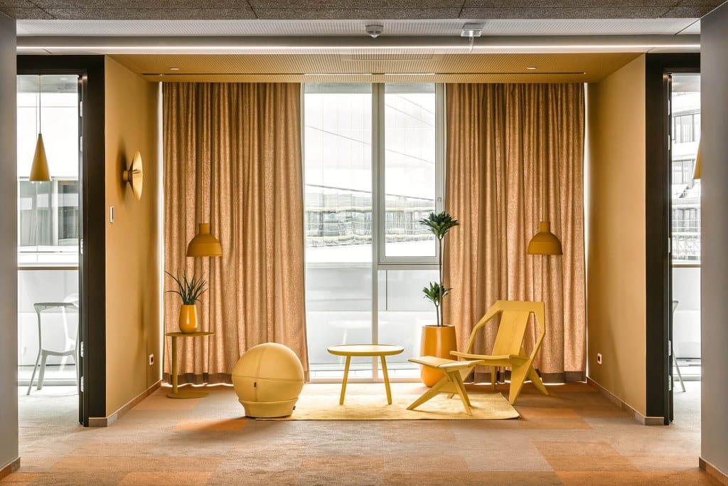 yellow themed workspace interior supporting creative collaboration Nordeus office