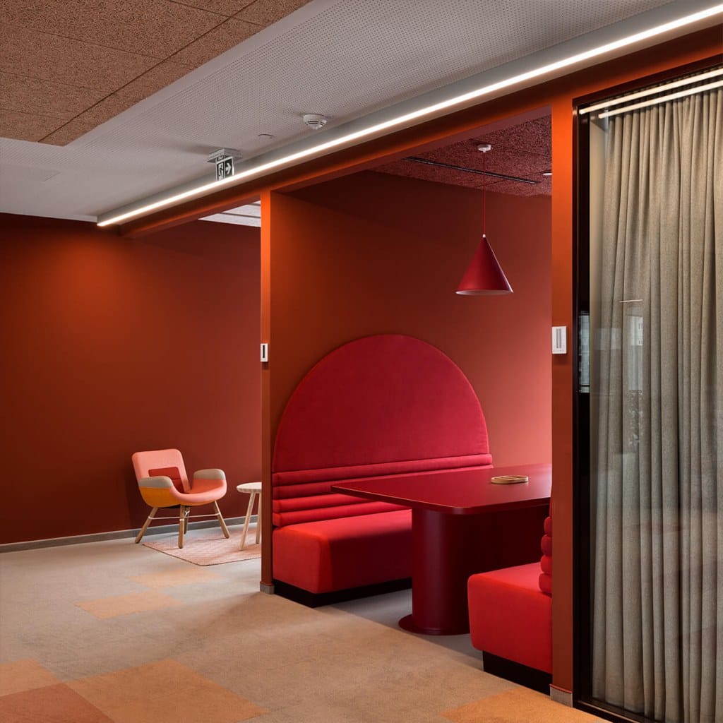 red lounge space with Vitra chair