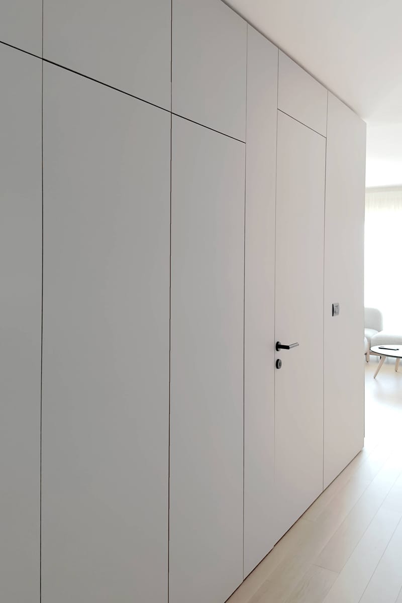 wall panel cladding with flush hidden door without frame Flow apartment interior